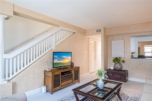 2080 W 1st St Unit 206, Fort Myers, FL 33901 - tiled living area featuring stairway, decorative columns, and baseboards