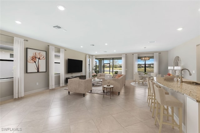 17021 Ashcomb Way, Estero, FL 33928 - living room featuring recessed lighting, light tile patterned floors, and a chandelier