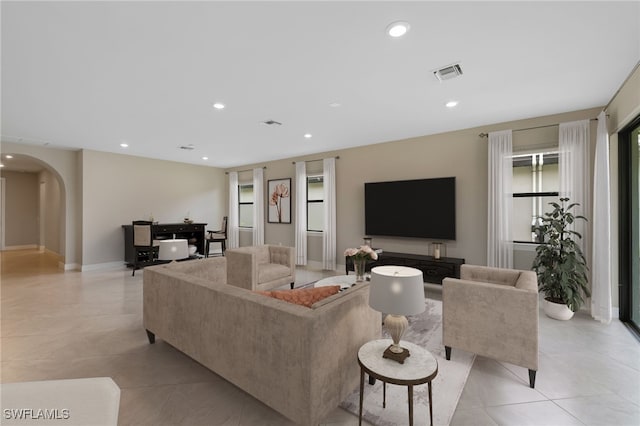 17021 Ashcomb Way, Estero, FL 33928 - living area with arched walkways, light tile patterned floors, and recessed lighting
