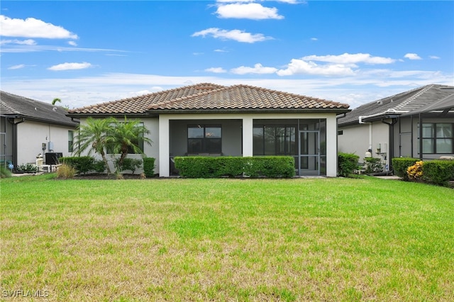 17021 Ashcomb Way, Estero, FL 33928 - rear view of property featuring a tile roof, stucco siding, and a yard
