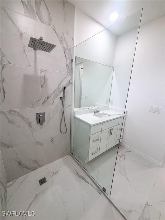 3413 28th St SW, Lehigh Acres, FL 33976 - bathroom featuring marble tiled flooring, a marble finish shower, vanity, and baseboards