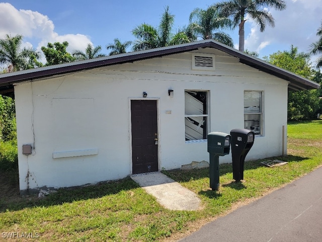 137 Standish Cir, North Fort Myers, FL 33903 - view of front of property with a front lawn and stucco siding