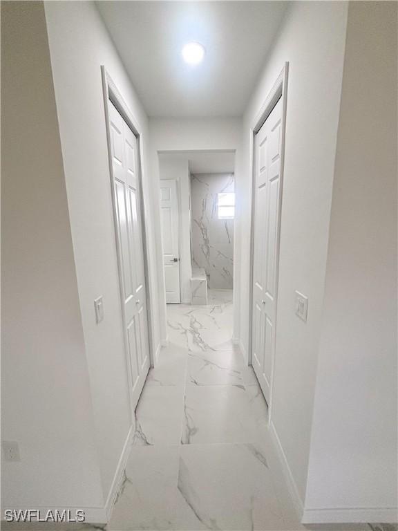 4113 19th St SW, Lehigh Acres, FL 33976 - hallway with light marble finish floors and baseboards
