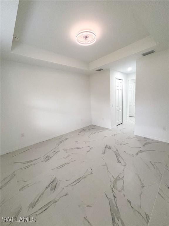 3806 15th St W, Lehigh Acres, FL 33971 - unfurnished room featuring a raised ceiling and baseboards