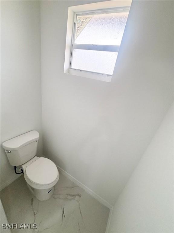 3806 15th St W, Lehigh Acres, FL 33971 - bathroom featuring toilet and marble finish flooring