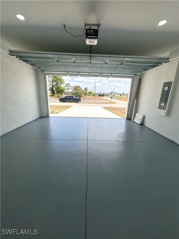 3806 15th St W, Lehigh Acres, FL 33971 - garage with electric panel, a garage door opener, and recessed lighting