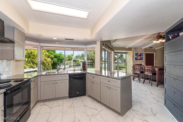1704 Coral Way N, Fort Myers, FL 33917 - kitchen featuring black appliances, gray cabinetry, a sink, a peninsula, and healthy amount of natural light