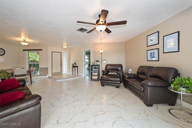 1704 Coral Way N, Fort Myers, FL 33917 - living area with healthy amount of natural light, light marble finish floors, and ceiling fan