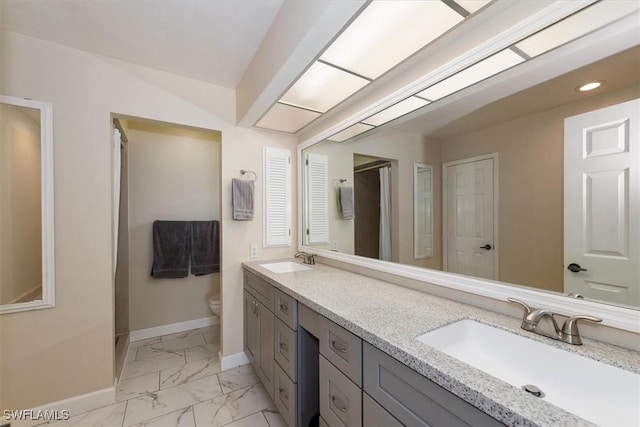 1704 Coral Way N, Fort Myers, FL 33917 - full bath featuring baseboards, double vanity, marble look tiles, toilet, and recessed lighting