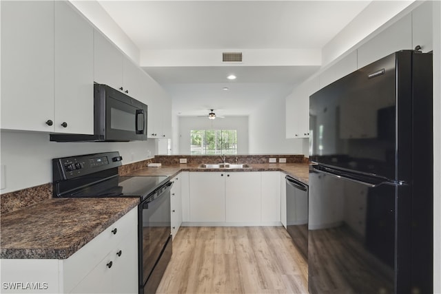 411 Valerie Way Unit 103, Naples, FL 34104 - kitchen featuring black appliances, dark countertops, light wood finished floors, white cabinetry, and recessed lighting