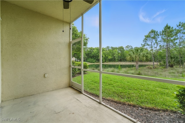 411 Valerie Way Unit 103, Naples, FL 34104 - unfurnished sunroom with ceiling fan, view of wooded area, and a water view