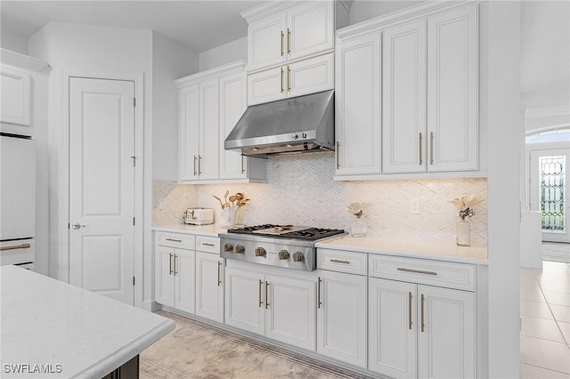 8341 Promoso Ct, Naples, FL 34114 - kitchen featuring under cabinet range hood, stainless steel gas cooktop, refrigerator, and light countertops