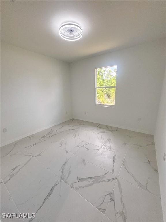 2505 48th St SW, Lehigh Acres, FL 33976 - unfurnished room with baseboards and marble finish floors