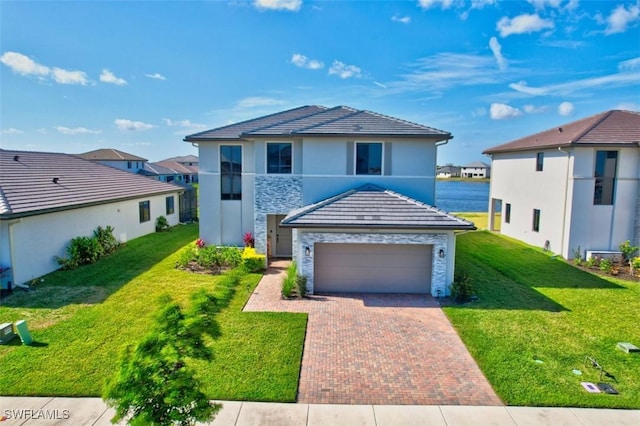 5273 Lamone Ln, Ave Maria, FL 34142 - view of front of property with decorative driveway, a garage, stone siding, and a front lawn