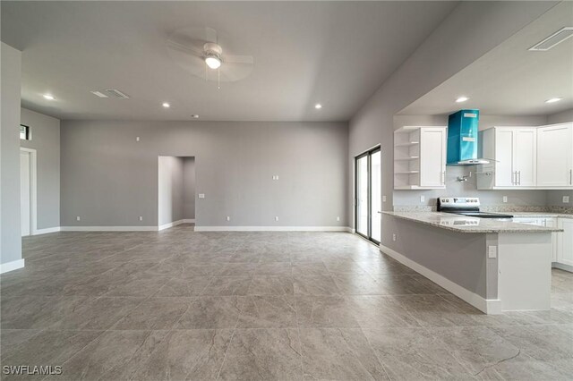 2458 NW 21st Ter, Cape Coral, FL 33993 - kitchen featuring wall chimney exhaust hood, electric range, ceiling fan, white cabinets, and light stone counters