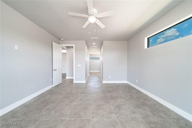 2458 NW 21st Ter, Cape Coral, FL 33993 - spare room featuring a ceiling fan and baseboards