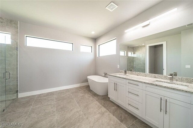 2458 NW 21st Ter, Cape Coral, FL 33993 - bathroom featuring double vanity, a stall shower, a soaking tub, and baseboards