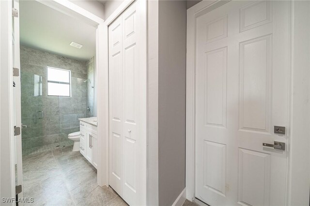 2458 NW 21st Ter, Cape Coral, FL 33993 - bathroom featuring a shower stall, vanity, and toilet