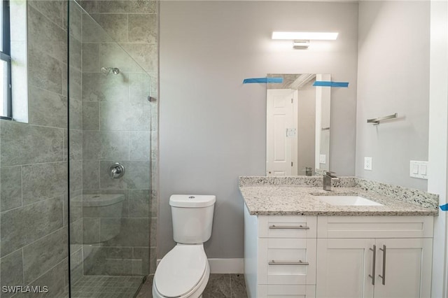 2458 NW 21st Ter, Cape Coral, FL 33993 - full bathroom featuring toilet, vanity, a stall shower, and baseboards