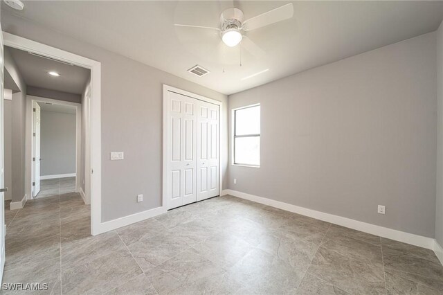 2458 NW 21st Ter, Cape Coral, FL 33993 - unfurnished bedroom with baseboards, a closet, and ceiling fan
