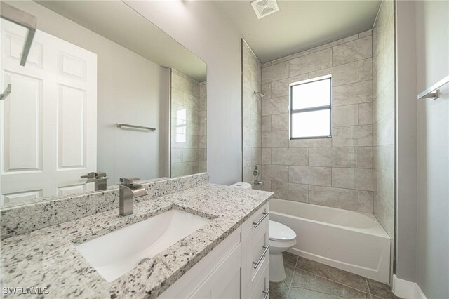 2458 NW 21st Ter, Cape Coral, FL 33993 - full bathroom with vanity, toilet, shower / washtub combination, and tile patterned floors