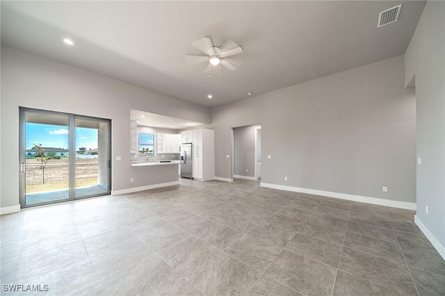 2458 NW 21st Ter, Cape Coral, FL 33993 - unfurnished living room featuring ceiling fan, baseboards, and recessed lighting