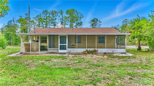 1201 E 15th St, Lehigh Acres, FL 33972 - view of front of house featuring a sunroom and a front lawn