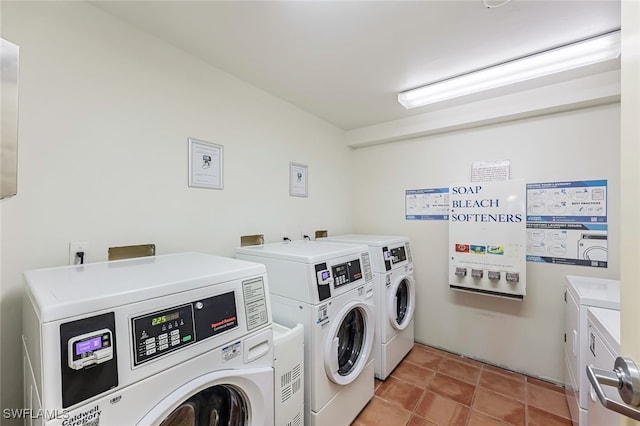 8771 Estero Blvd Unit 807, Fort Myers Beach, FL 33931 - community laundry room with washer and dryer and light tile patterned floors