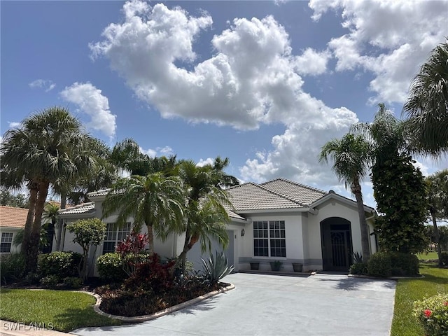 10951 Callaway Greens Ct, Fort Myers, FL 33913 - mediterranean / spanish-style house featuring concrete driveway, stucco siding, a tile roof, and an attached garage