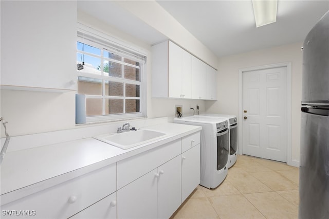 14221 Patty Berg Dr, Fort Myers, FL 33919 - laundry room with washing machine and clothes dryer, cabinet space, and light tile patterned floors