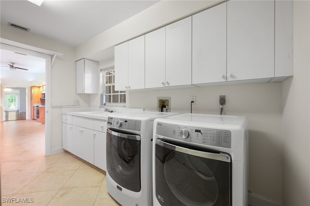 14221 Patty Berg Dr, Fort Myers, FL 33919 - washroom featuring independent washer and dryer, cabinet space, light tile patterned floors, and baseboards