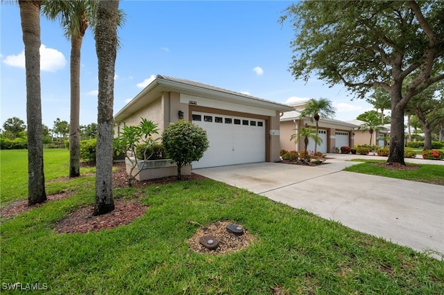 14221 Patty Berg Dr, Fort Myers, FL 33919 - view of front of house with driveway, a garage, stucco siding, and a front lawn