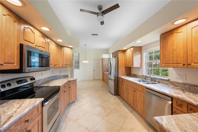 14221 Patty Berg Dr, Fort Myers, FL 33919 - kitchen featuring appliances with stainless steel finishes, a ceiling fan, light tile patterned floors, decorative light fixtures, and a sink