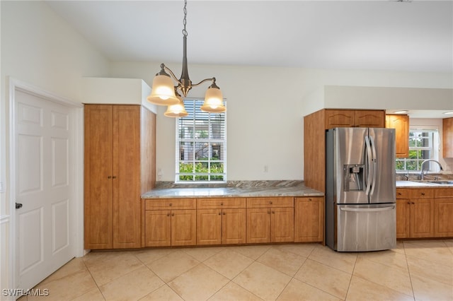 14221 Patty Berg Dr, Fort Myers, FL 33919 - kitchen with stainless steel refrigerator with ice dispenser, brown cabinetry, a chandelier, and a sink