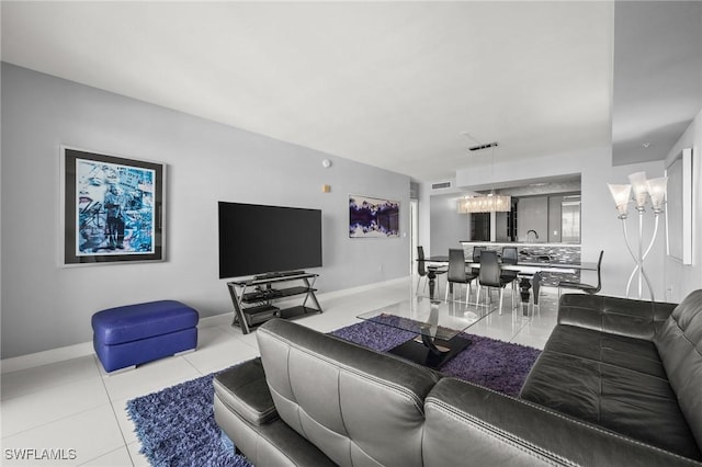 3000 Oasis Grand Blvd Unit 2103, Fort Myers, FL 33916 - tiled living area featuring a chandelier and baseboards