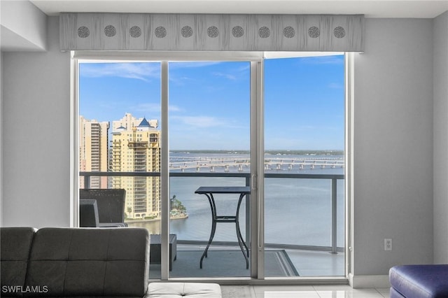 3000 Oasis Grand Blvd Unit 2103, Fort Myers, FL 33916 - tiled living area featuring a water view and baseboards