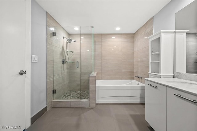 3000 Oasis Grand Blvd Unit 2103, Fort Myers, FL 33916 - full bathroom featuring tile patterned floors, a garden tub, vanity, a shower stall, and recessed lighting