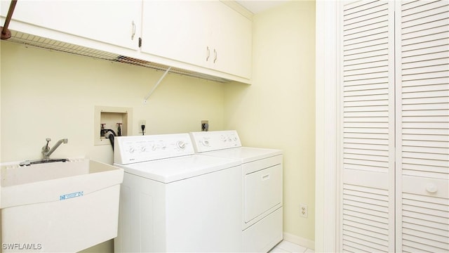 319 Reynolds Ct Unit M12, Naples, FL 34112 - washroom featuring cabinet space, separate washer and dryer, light tile patterned floors, and baseboards