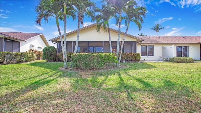 319 Reynolds Ct Unit M12, Naples, FL 34112 - view of front of house featuring stucco siding, a front lawn, and a sunroom