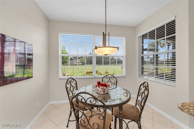 1630 Winding Oaks Way Unit 102, Naples, FL 34109 - dining room with light tile patterned floors, healthy amount of natural light, and baseboards