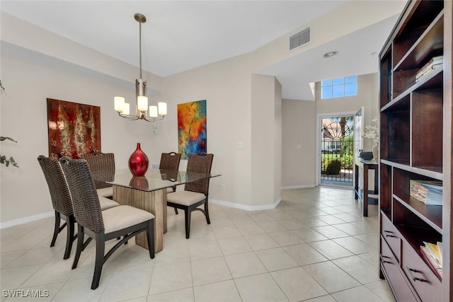 1630 Winding Oaks Way Unit 102, Naples, FL 34109 - dining room featuring a chandelier, baseboards, and light tile patterned flooring