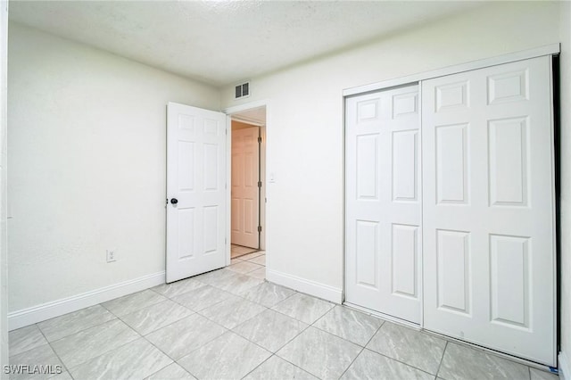 2938 Market St, Fort Myers, FL 33916 - unfurnished bedroom featuring baseboards, a closet, and light tile patterned flooring