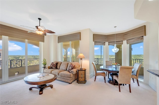 2738 Tiburon Blvd E Unit Ph-B502, Naples, FL 34109 - living room with healthy amount of natural light, a ceiling fan, light colored carpet, and baseboards