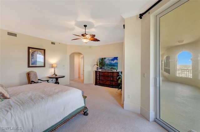 2738 Tiburon Blvd E Unit Ph-B502, Naples, FL 34109 - bedroom featuring arched walkways, light carpet, and ceiling fan