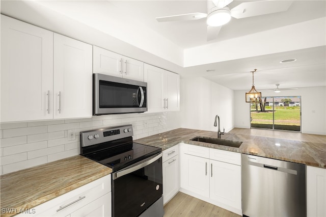 16320 Kelly Cove Dr Unit 270, Fort Myers, FL 33908 - kitchen with stainless steel appliances, a sink, stone countertops, and backsplash