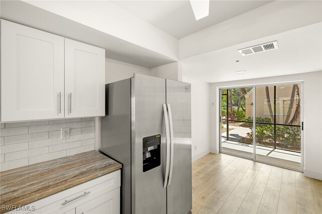 16320 Kelly Cove Dr Unit 270, Fort Myers, FL 33908 - kitchen featuring stainless steel refrigerator with ice dispenser, tasteful backsplash, white cabinetry, light wood-style floors, and baseboards