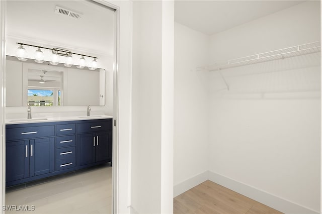 16320 Kelly Cove Dr Unit 270, Fort Myers, FL 33908 - full bath featuring double vanity, baseboards, wood finished floors, and a walk in closet