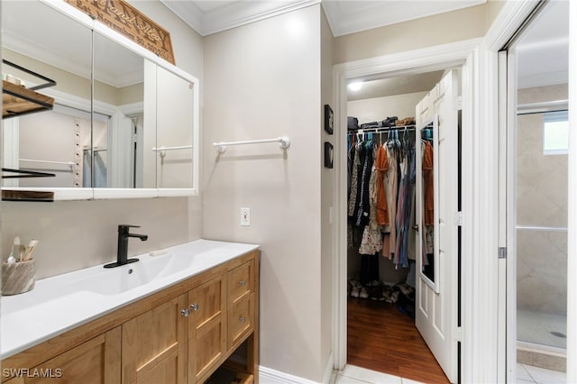 955 Hidden Terrace Rd, Naples, FL 34104 - full bathroom featuring vanity, a spacious closet, a shower stall, ornamental molding, and wood finished floors
