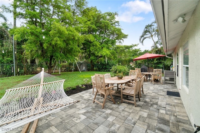 955 Hidden Terrace Rd, Naples, FL 34104 - view of patio / terrace featuring outdoor dining space and view of scattered trees