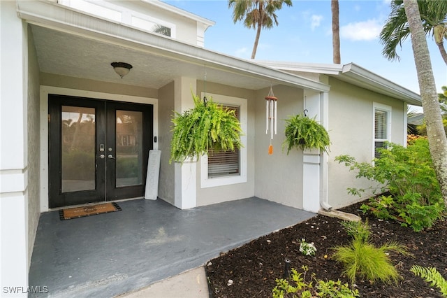 955 Hidden Terrace Rd, Naples, FL 34104 - view of exterior entry with french doors and stucco siding